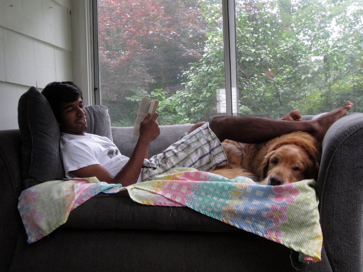 Reading a book on the couch with Simba
